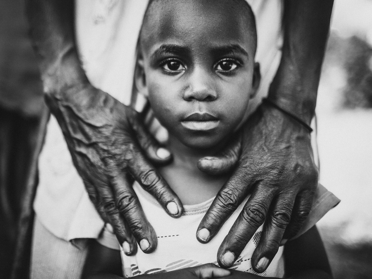 Child in Uganda hands holding here